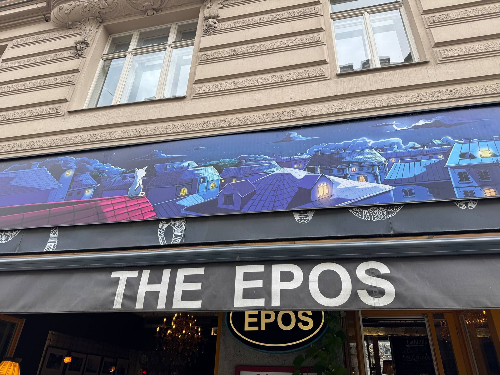 Fassade Café Epos mit Schriftzug und Illustration